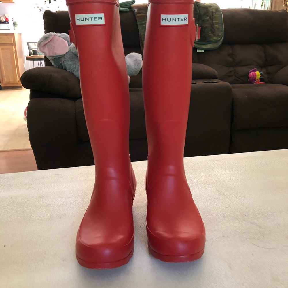 Red knee length hunter rain boots
